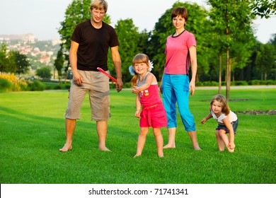 Family Playing With Frisbee In Park