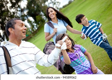 Family Playing Golf And Walking To The Next Hole