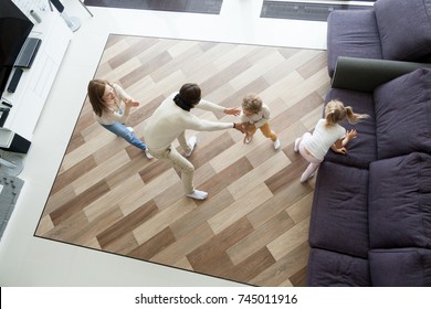 Family Playing Hide And Seek Game At Home, Mother And Kids Hiding Clapping Hands While Blindfolded Father Seeking Catching Children Wife, Parents And Son Daughter Having Fun In Living Room, Top View