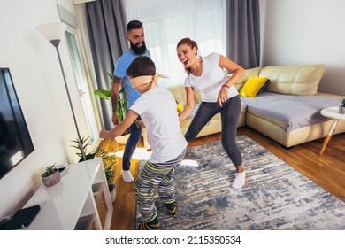 Family Playing Hide And Seek At Home, Happy Boy Having Fun With Mom And Dad.