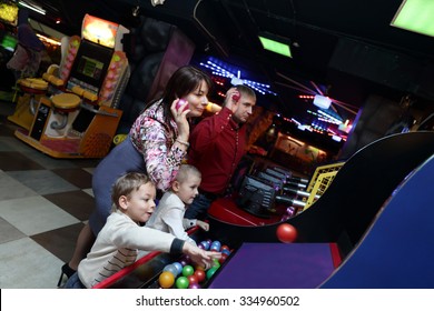 Family Playing At The Indoor Amusement Park