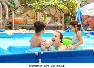 Family Playing And Laughing Happily As They Play In A Backyard Swimming Pool.