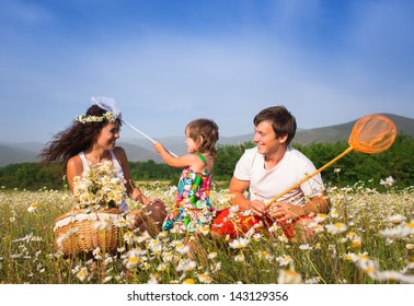 Family playing on the camomile meadow