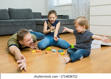 The family is playing on the floor in the room. Happy family concept. - Shutterstock ID 1714838722