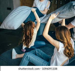 Family Is Playing Pillow Fight In Studio In Blue Jeans With Red Hair Brown