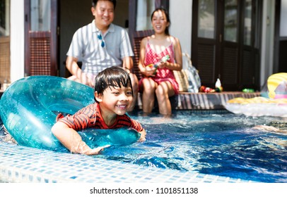 Family Playing In A Pool