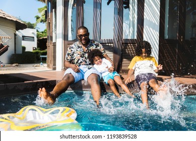 Family Playing In A Pool