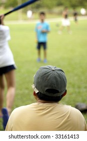 Family Playing Softball Together, Focus On Father Wearing Cap