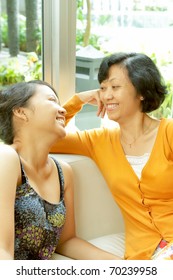 Family Portrait Of Asian Ethnic Mature Mother Enjoy Talking With Teen Daughter