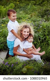 Family. Portrait of beautiful cheerful mother with her cute sons having fun together