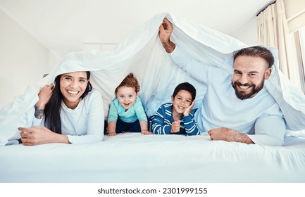 Family, portrait and blanket fort in bed with children and parents, happy and playing in their home. Face, under and sheet by kids with mom and dad in bedroom, fun and waking up, relax and smile - Powered by Shutterstock