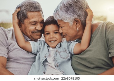 Family, portrait and child with grandparents in a living room, hug and happy, love and sweet while bonding in their home. Embrace, grandchild and grandmother with grandfather in a lounge hugging