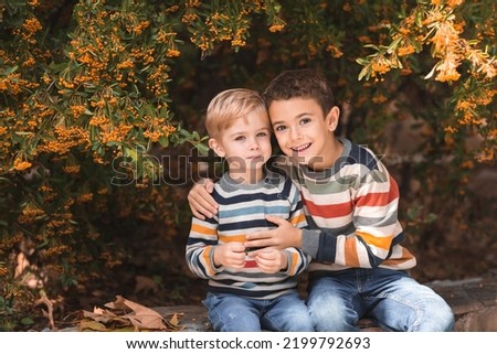 Family portrait. Embrace of two brothers. Two cute cheerful boys are hugging. Friendship and brotherly love.