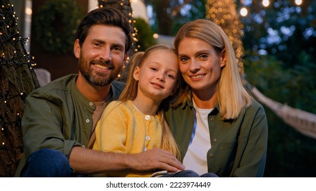 Family Portrait Happy Caucasian Faces Male Female And Kid Woman Bearded Man And Little Girl Father Mother And Child Daughter Outdoors Smiling Close Up Looking At Camera In Evening In Camping Backyard