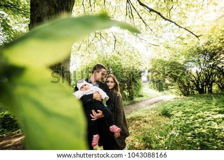 Family portrait in the park. Family with a child in the park. Rest of happy family in nature.