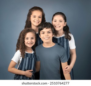 Family portrait three girls, one boy isolated on blue background - Powered by Shutterstock