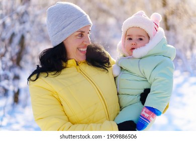 Family Portrait In The Winter Forest, Mother And Child, Bright Sunlight And Shadows On The Snow, Beautiful Nature.