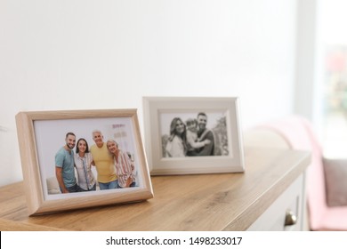 Family portraits in frames on cabinet indoors - Shutterstock ID 1498233017