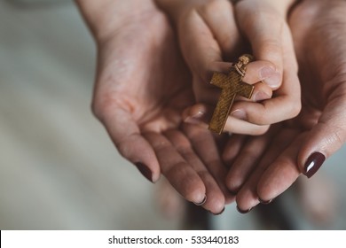 Family Prayer. Mother And Child Hands With Wooden Rosary