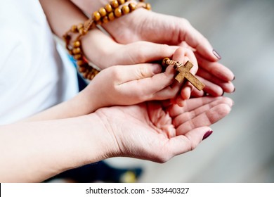 Family Prayer. Mother And Child Hands With Wooden Rosary