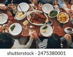 Family, praying and grace for thanksgiving, dinner and celebration outdoor with food, wine or love. Group of people, faith and together at table for holiday, above and gratitude with drink or turkey