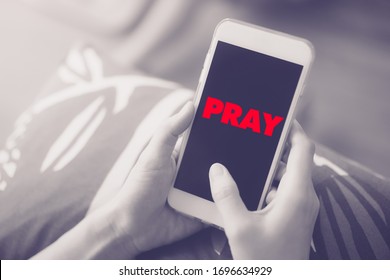 Family Praying And Worship To GOD With Church Online Sunday Service.Live Church With Bible.Woman Hand Holding On Smartphone At Home For Good Friday Night.Quarantine From Covid-19 Coronavirus Pandemic.