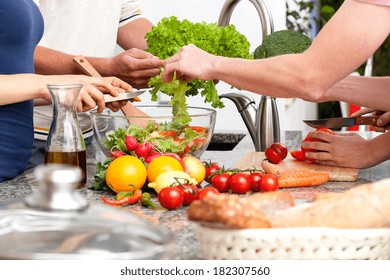 Family Preparing Lunch Together At Home