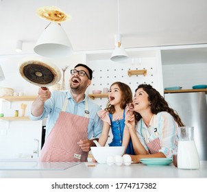 Family preparing pancakes in the kitchen at home - Powered by Shutterstock