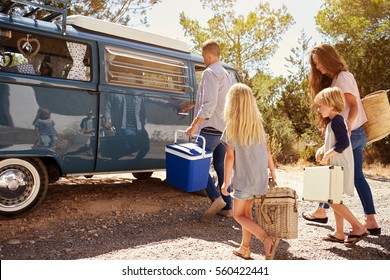 Family Preparing Their Camper Van For A Road Trip, Side View