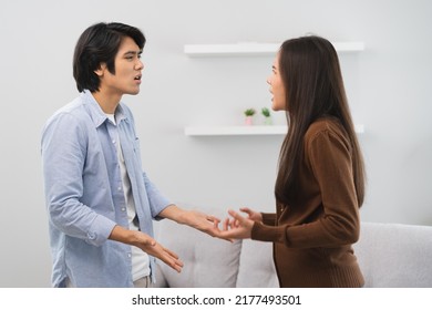 Family Problems, Asian Couple Quarrel Together At Home. Woman Angry On Man And Man Feel Annoy.