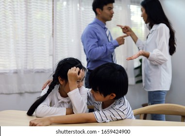 Family problems concept, father and mother quarreling in the house so causing children to feel bad.