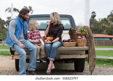 Family With Produce In Truck Bed