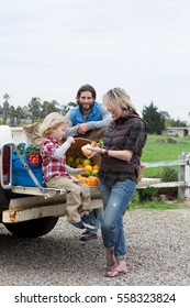 Family With Produce In Truck Bed