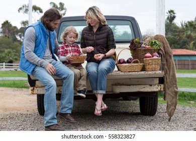 Family With Produce In Truck Bed