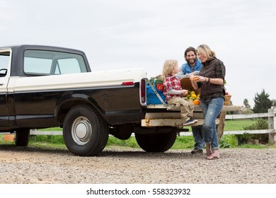 Family With Produce In Truck Bed