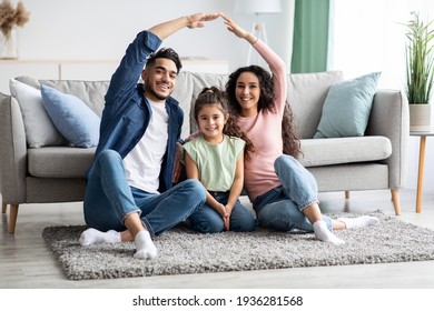 Family Protection. Mom And Dad Making Roof Of Hands Above Their Daughter