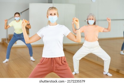 Family In Protective Masks Are Engaged In Sports Dancing In The Gym