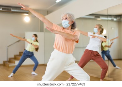 Family In Protective Masks Are Engaged In Sports Dancing In The Gym