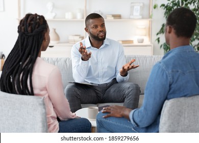 Family Psychotherapy. African American Couple Listening To Counselor's Advices During Therapy Session In Office, Black Spouses Having Marital Counseling Meeting With Therapist, Selective Focus