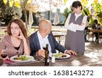 Family quarrel during lunch in an open-air restaurant