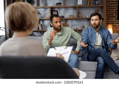 Family quarrel at the reception at the psychologist. LGBT couple at a psychotherapist's appointment. Psychologist for gays. Support for the LGBT community in visiting a psychologist. - Shutterstock ID 2282070161