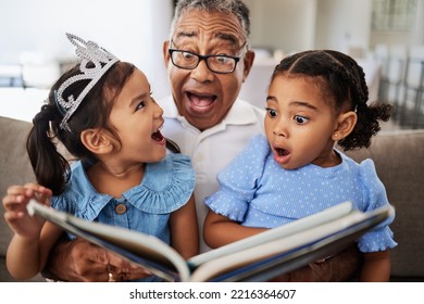 Family, reading book and children with grandpa for wow, surprised and excited expression in a living room with people bonding. Grandfather or man, kids and story time at home with man and girls - Powered by Shutterstock