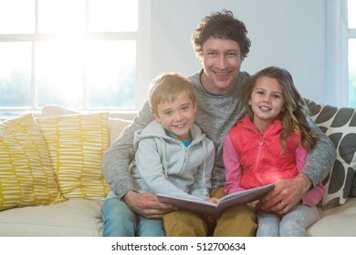 Family Reading A Book At Home