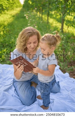 Similar – Reading stories Parenting