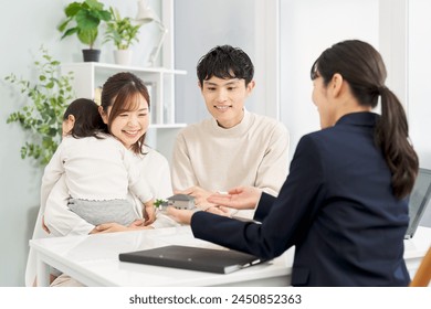 A family receiving real estate information - Powered by Shutterstock