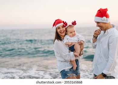 Family In A Red Santa Hat Walk On The Beach. Family Celebrate Christmas And New Year At Tropics. New Year Concept.