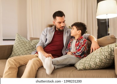 family, relationships and trust concept - father talking to his sad little son at home in evening - Powered by Shutterstock