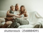 Family, relax and bonding, parents with children at home with love and care in living room and relationship. Childhood, parenting and woman with man, toddler and newborn on couch with time together