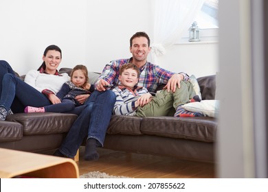 Family Relaxing Indoors Watching Television Together