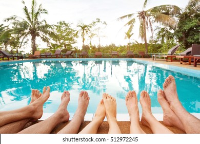 Family Relaxing Near Swimming Pool In Hotel, Feet Of Group Of Friends Or Parents With Children, Happy Beach Holidays